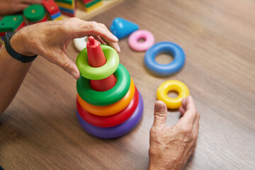 Mature man recovering motor skills in clinic