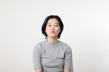 Young attractive Asian chinese malay woman pose face body expression mode emotion on white background kiss