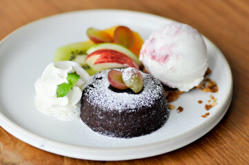 chocolate cake or chocolate lava cake with ice cream and fruit