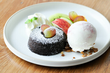 chocolate cake or chocolate lava cake with ice cream and fruit