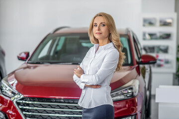 Blonde business woman in car dealership