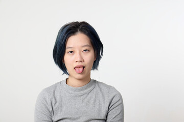 Young attractive Asian chinese malay woman pose face body expression mode emotion on white background tired tongue out