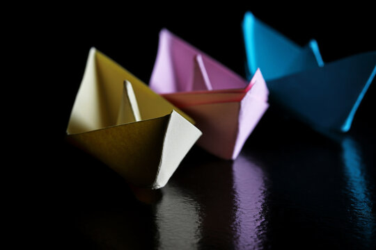 origami paper boat on a black background