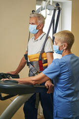 Professional physiotherapist working with patient in rehabilitation center