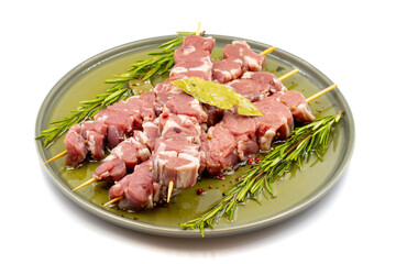 Marinated raw lamb skewers on a white background. Lamb skewers marinated in olive oil and various spices