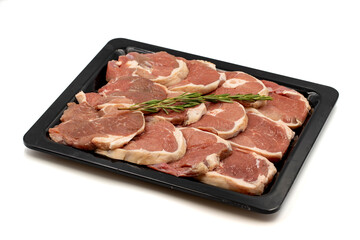 Marinated raw lamb ribeye on a white background. Lamb ribeye marinated in olive oil and various spices