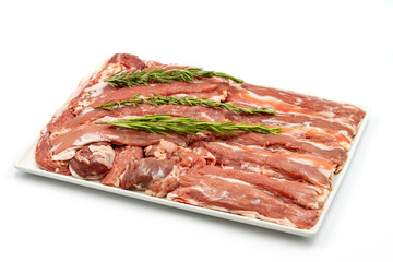 Marinated raw lamb tenderloin on a white background. Lamb tenderloin marinated with olive oil and various spices