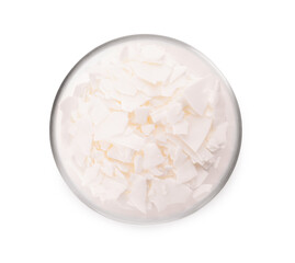 Wax flakes in glass bowl on white background, top view. Homemade candle material