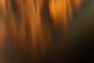 Defocused glow background. Bokeh rays. Solar blast effect. Sun beam leak. Blur golden orange black...