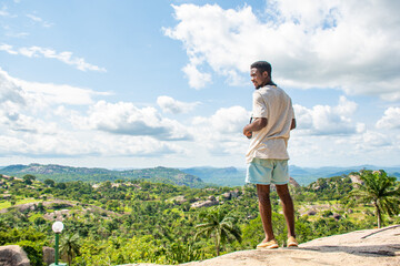 young black man staring into a nature landscape