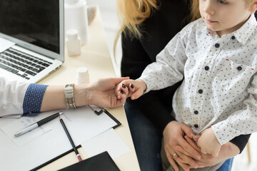 Pediatrician Meeting With Mother And Child In Hospital