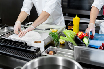 Chefs prepare meals in the kitchen