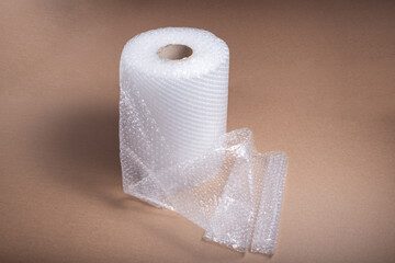 Roll of bubble film on brown cardboard background