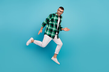 Fototapeta na wymiar Full body photo of happy young funky man jump up run sale dream isolated on pastel blue color background