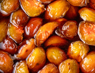 making ambarella or june plum jam, boiling in sugar syrup, homemade sweet food closeup view taken from above
