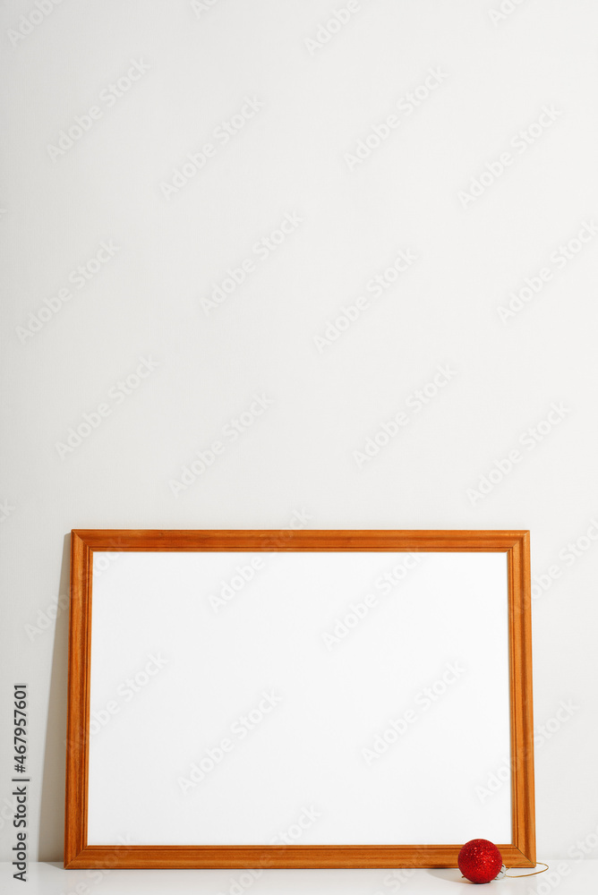 Poster horizontal frame mock-up with empty space for branding, picture or text and christmas red ball toy a
