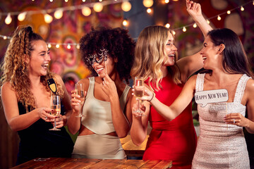 Multi-Cultural Group Of Female Friends Celebrating At 2022 New Year Party Night Out In Bar - obrazy, fototapety, plakaty