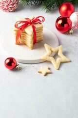 Fototapeta na wymiar Shortbread cookies. Traditional Austrian linzer Christmas or New Year cookies. Homemade sweet present. Delicious gift. Composition with christmas ball and spruce branches.