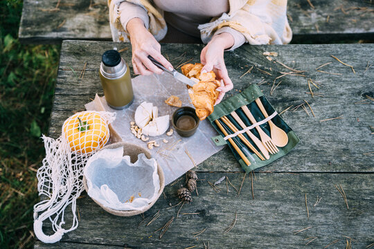 Vacation, healthy lifestyle, zero waste and sustainable plastic free concept. Cozy breakfast with cheese croissant, camembert at wooden tavle outdoor.