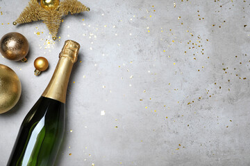 Happy New Year! Flat lay composition with bottle of sparkling wine on light grey table, space for...