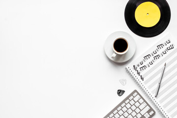 Handwritten music sheets and vinyl record, top view. Compose music concept