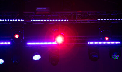 Blue-pink spotlights at a concert at night.
