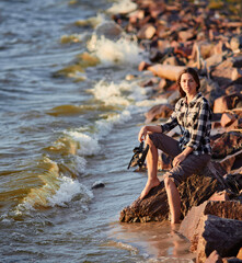 Young woman walking along beach. Landscape with people and copy space.