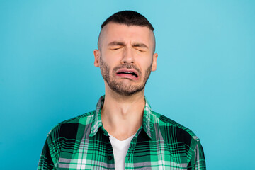 Photo of unhappy upset young man cry bad mood stressed problems isolated on blue color background