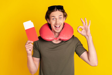 Photo of young man happy positive smile trip abroad show okay alright feedback sign isolated over yellow color background