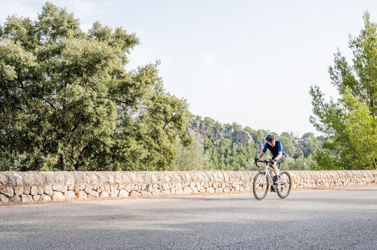 Senior athlete doing road cycling in the mountains. Image with copy space