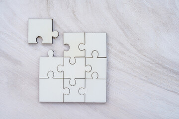 Top view of jigsaw puzzle with connecting put on the white wood in the office, Strategies for business planning for future success concept.