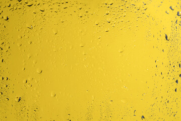 Yellow backgrond with water drops.