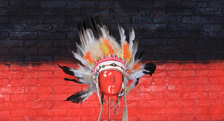 indian apache headdress with feathers, red brick wall