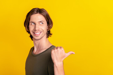 Profile side photo of young interested guy look point thumb empty space promo discount isolated...