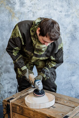 Platter. Kitchen utensils. Master woodcarver creates a round plate of wooden bar, Saw. Processing wood and creating toys from it. Souvenir made of wood.