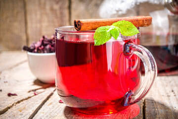 Red hibiscus tea, in glass cup. Healthy organic hot drink copy space