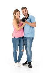 Surprised young couple looking at photos on their camera