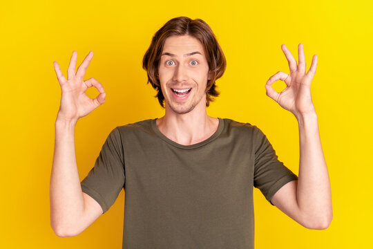 Photo of young cheerful man happy positive smile show okey coo sign recommend great isolated over yellow color background