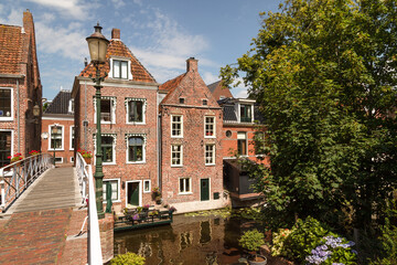 Fototapeta premium Old houses along the canal in the picturesque town of Appingedam in the province of Groningen; Netherlands.