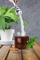 In a cup of tea, pour a sugar substitute. Stevia, erythritol.