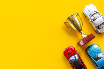 Sport rally car champion award - golden trophy cup with car models, top view - obrazy, fototapety, plakaty