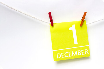 December 1st . Day 1 of month, Calendar date. Paper cards with calendar day hanging rope with clothespins on white background. Winter month, day of the year concept.