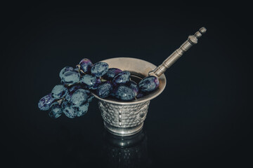Bronze mortar with freshly harvested natural grapes.