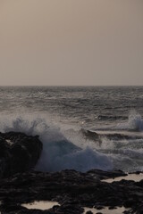 Some waves breaking against some rocks