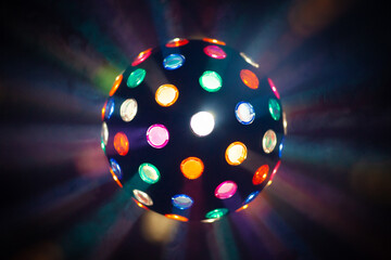 disco ball on black background. light rays through the smoke