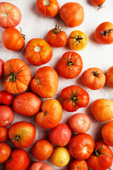 Tomatoes on a white background. A fresh crop of vegetables. Drops of water on red tomatoes. Organic food
