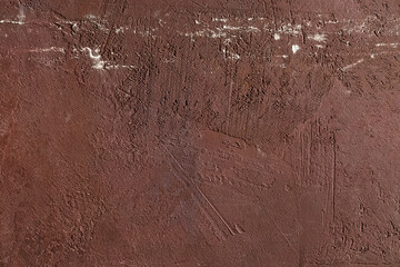 Red scratched and weathered plaster on concrete wall texture. Abstract background