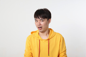 Young good looking Asian chinese malay man pose face body expression mode emotion on white background shocked surprised disgusted