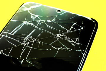 Broken tempered glass screen protector. Crashed smartphone. Close up.