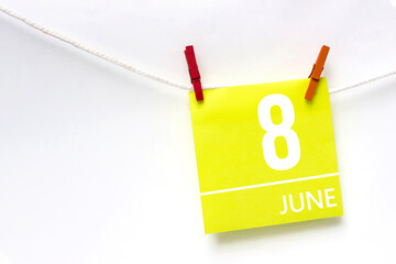 June 8th. Day 8 of month, Calendar date. Paper cards with calendar day hanging rope with clothespins on white background. Summer month, day of the year concept.